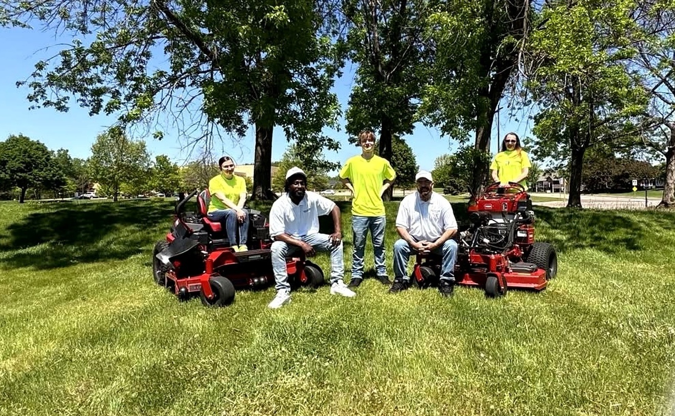 Minneapolis North Outdoor Services crew standing with lawn equipment