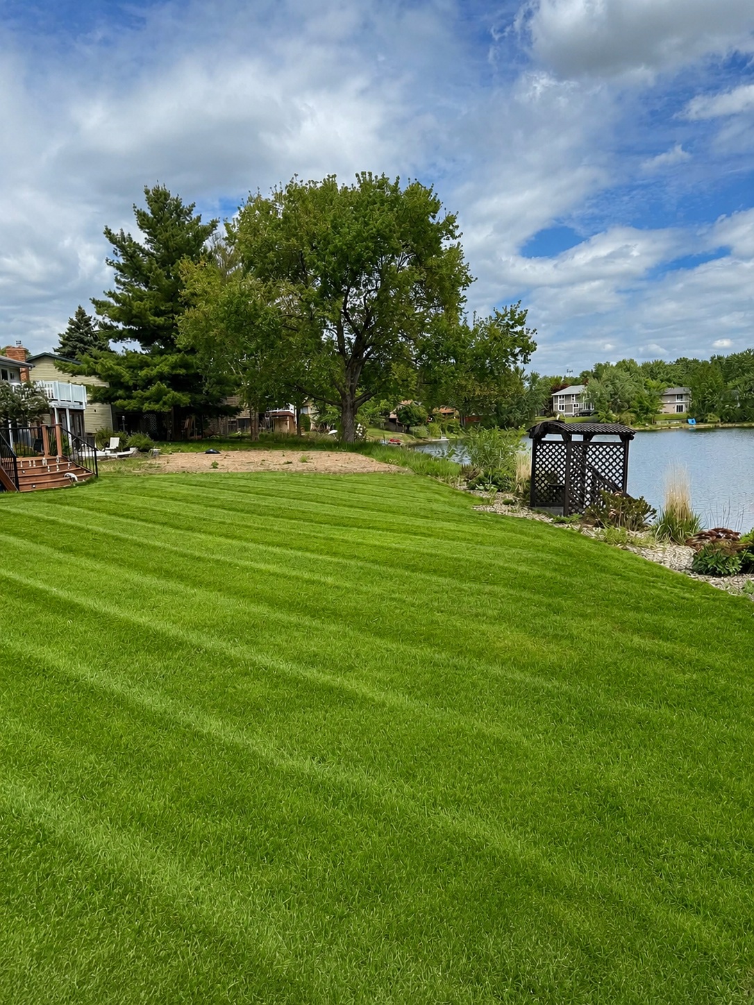 Freshly mowed lakeside lawn with clean stripes